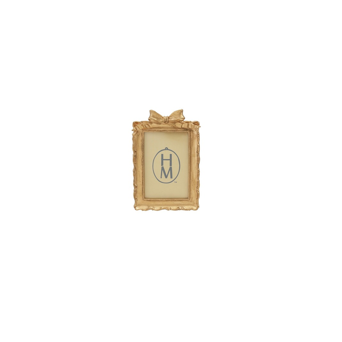 gold picture frame with a bow on a white background