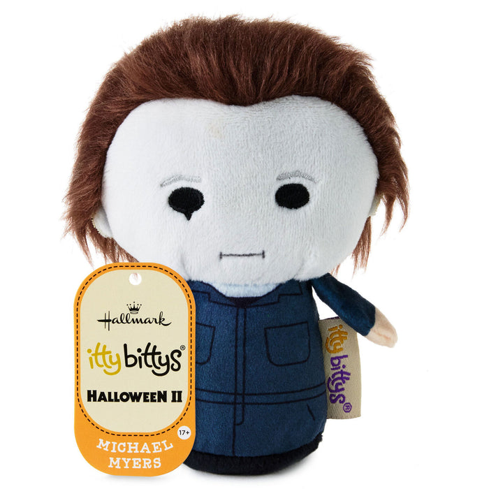 Hallmark It's Bittsys Michael Myers plush toy from Halloween II, featuring brown hair, a white face, and a blue jumpsuit, with its orange and white hangtag visible.