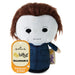 Hallmark It's Bittsys Michael Myers plush toy from Halloween II, featuring brown hair, a white face, and a blue jumpsuit, with its orange and white hangtag visible.