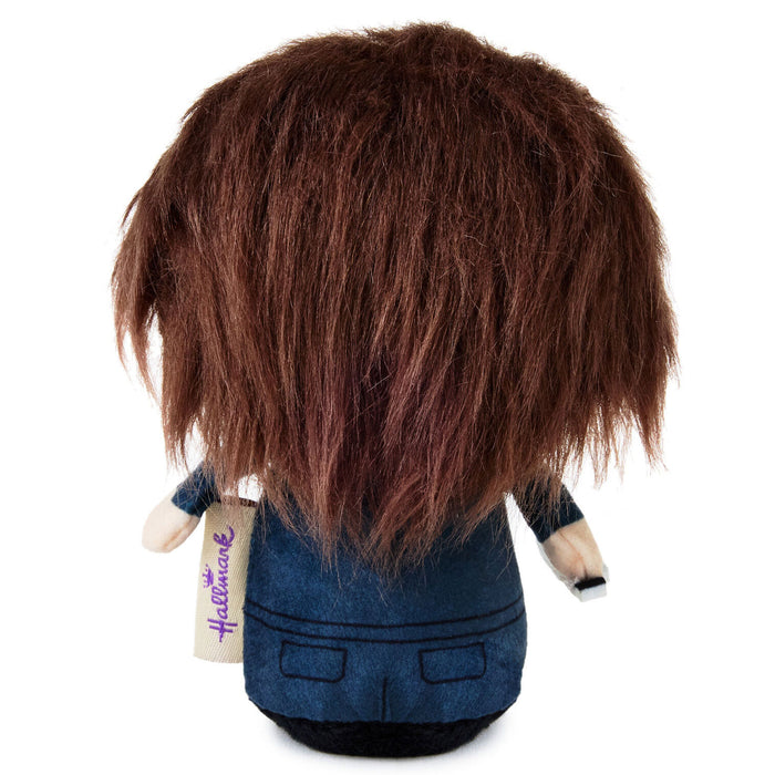 Back view of a Hallmark plush doll with messy dark brown hair, wearing a blue denim-style jacket and black skirt, on a white background.