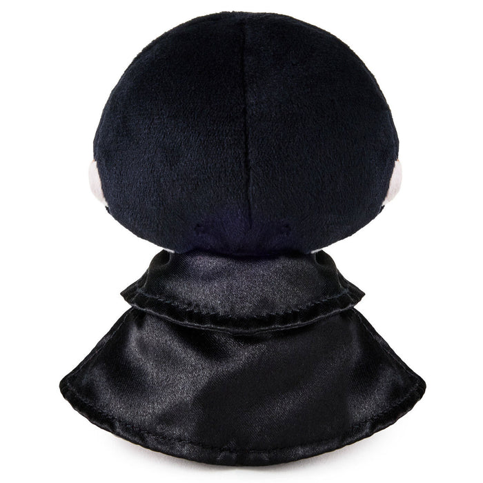 A plush doll or toy shown from the back, featuring a large round black head and a layered black satin-like collar, photographed on a plain white background.