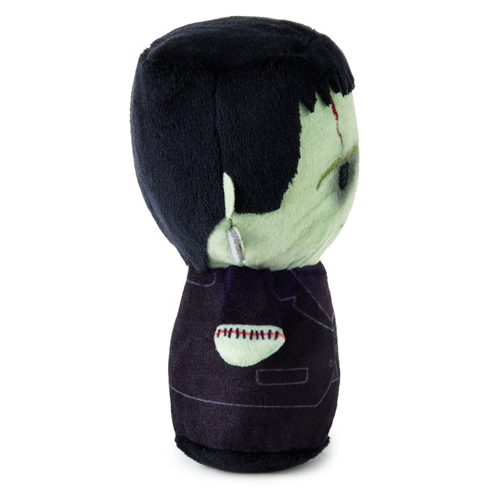 A plush toy shaped like a stylized Frankenstein's monster head and upper torso, with black hair, pale green skin, and a dark purple suit, shown against a plain white background.