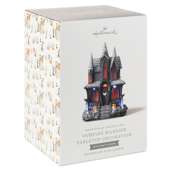 Hallmark Hauntsville Collection Vampire Mansion tabletop decoration retail box, showing the front and side packaging with a printed illustration of the haunted mansion and Halloween-themed side pattern.