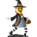 A painted Halloween witch figurine standing on a dark base against a plain white background. The figure has a yellow face, orange hair, a black hat and coat, a gray skirt, black-and-white striped legs, and holds an orange jack-o'-lantern bucket.