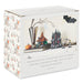 A white cardboard display box for a Hauntsville Halloween collectible village set, featuring printed artwork of spooky houses, a pumpkin, moon, bats, and decorative figures on the front panel, with a repeating haunted-house pattern on the side.