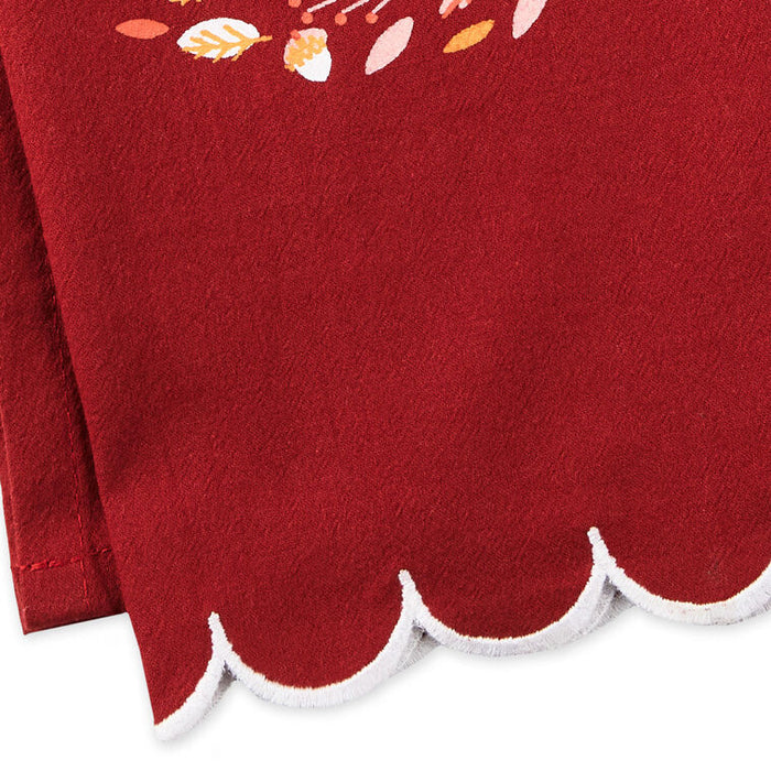 Red fabric with scalloped edge and floral patterns on a white background