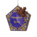 Decorative ornament resembling a chocolate frog in its packaging on a white background