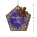 Decorative ornament resembling a chocolate frog packaging with a frog figure on a white background.