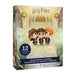 A boxed Harry Potter Countdown Calendar product shown at a slight angle on a plain white background. The package features the Harry Potter logo at the top, illustrated characters resembling Ron Weasley, Harry Potter, and Hermione Granger, Christmas wreaths, snowy ground, and text reading 'COUNTDOWN CALENDAR' and 'CALENDRIER DE COMPTE À RÉBOURS.