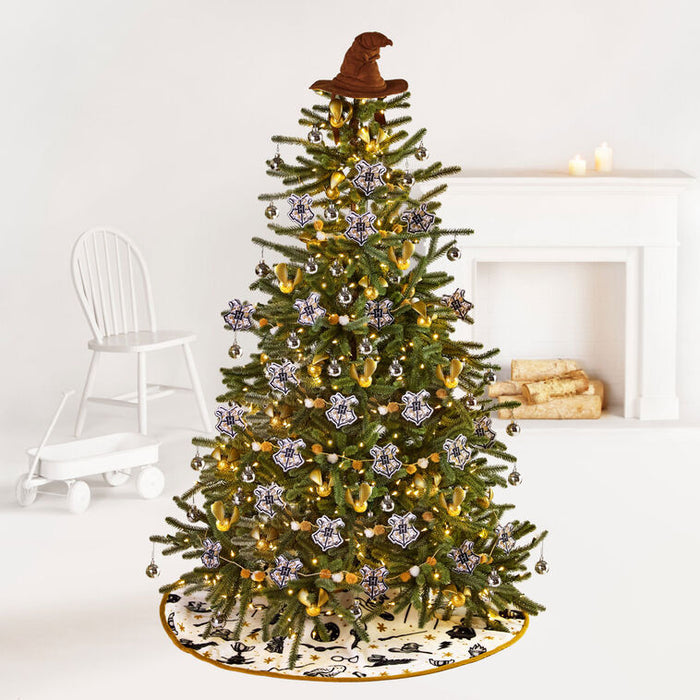 Decorated Christmas tree with ornaments and a hat on a white background