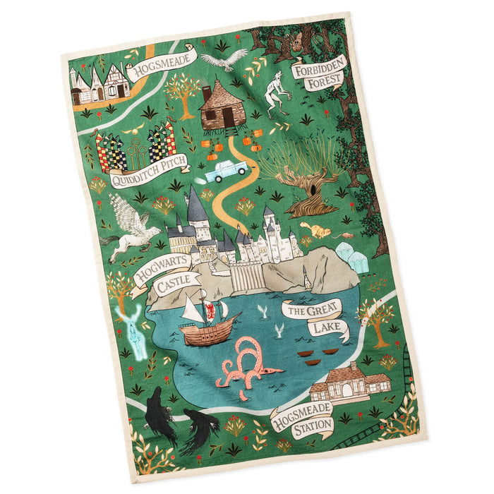 A square tea towel featuring a whimsical illustrated map of Hogwarts from Harry Potter, with labeled places like Hogwarts Castle, The Great Lake, and Hogwarts Station on a white background.