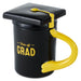 Black mug with yellow handle and graduation cap lid, featuring 'Hats off GRAD' text.