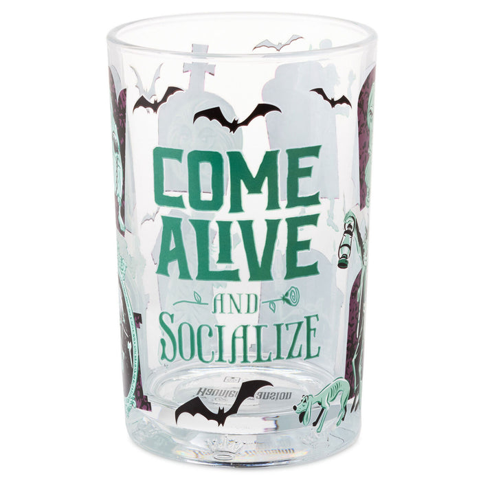 A clear glass tumbler with a Halloween-themed design featuring the text 'COME ALIVE AND SOCIALIZE' in green, black bats, a cross, and spooky illustrations on a white background.