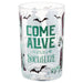 A clear glass tumbler with a Halloween-themed design featuring the text 'COME ALIVE AND SOCIALIZE' in green, black bats, a cross, and spooky illustrations on a white background.