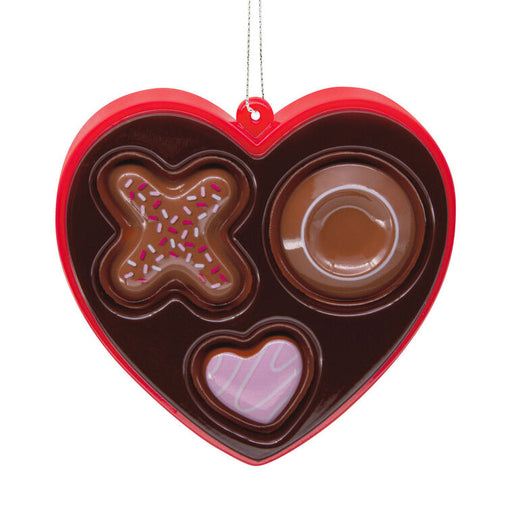 Heart-shaped chocolate mold with various shapes on a white background