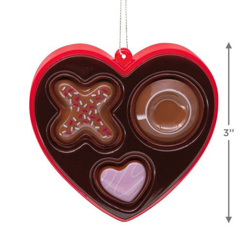 Heart-shaped chocolate mold with various shapes on a white background