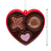 Heart-shaped chocolate mold with various shapes on a white background
