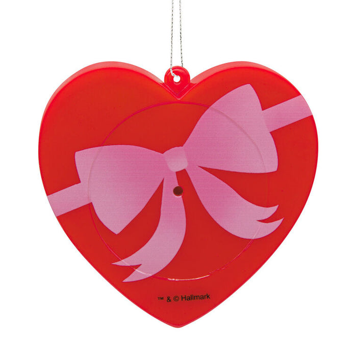 Heart-shaped ornament with a pink bow on a white background