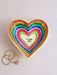 Heart-shaped trinket dish with colorful stripes and 'I Love You' message, placed on a light surface.