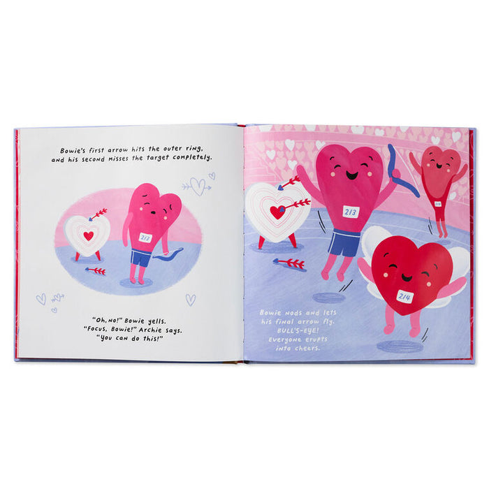Open book with colorful illustrations of hearts and arrows on a pink background