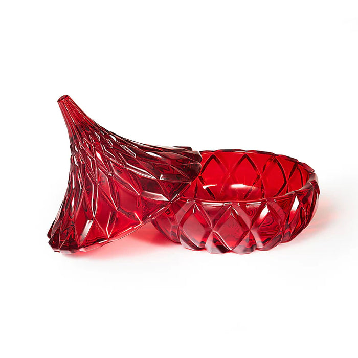 Red glass bowl with intricate cut patterns on a white background