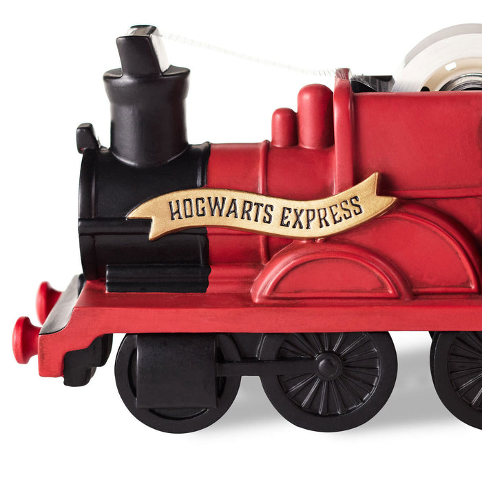 Red toy train engine with 'Hogwarts Express' sign on a white background