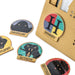 Set of Harry Potter house badges with a brown envelope in the background