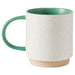 Speckled ceramic mug with green handle and base on a white background