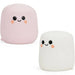 Two cute marshmallow-shaped poufs or small pillows on a white background, one light pink and one white, both with simple black cartoon eyes and smiling mouths plus peach rosy cheeks.