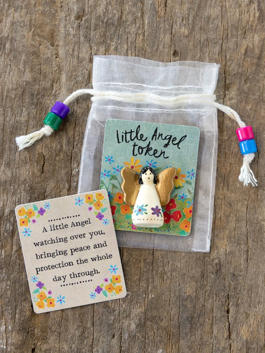Little Angel token with a card on a wooden surface
