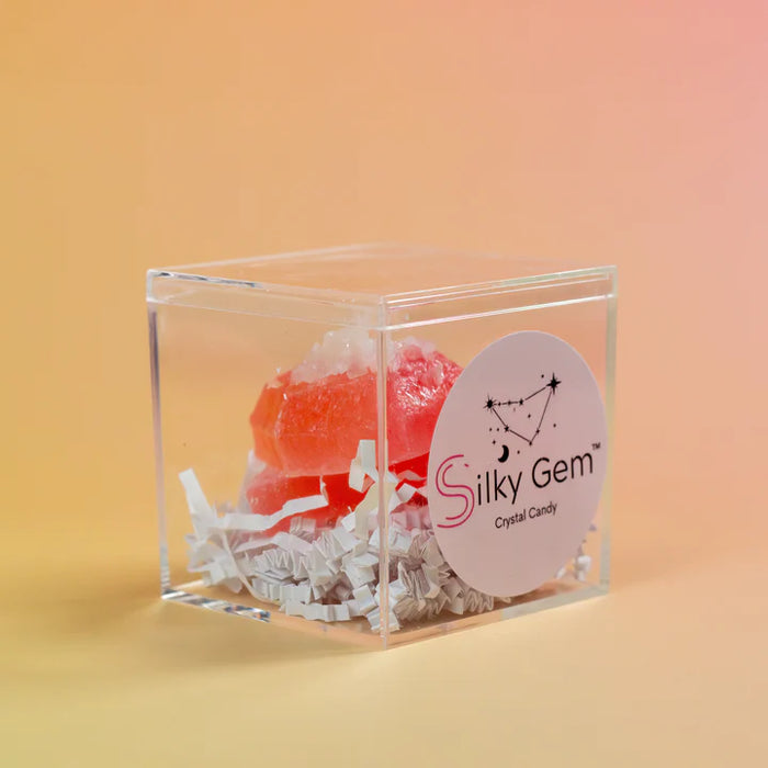 Crystal candy in a clear cube with 'Silky Gem' label on an orange background