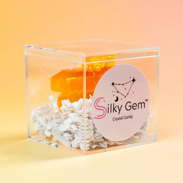 Silky Gem crystal candy in a clear box with a pink label on an orange background