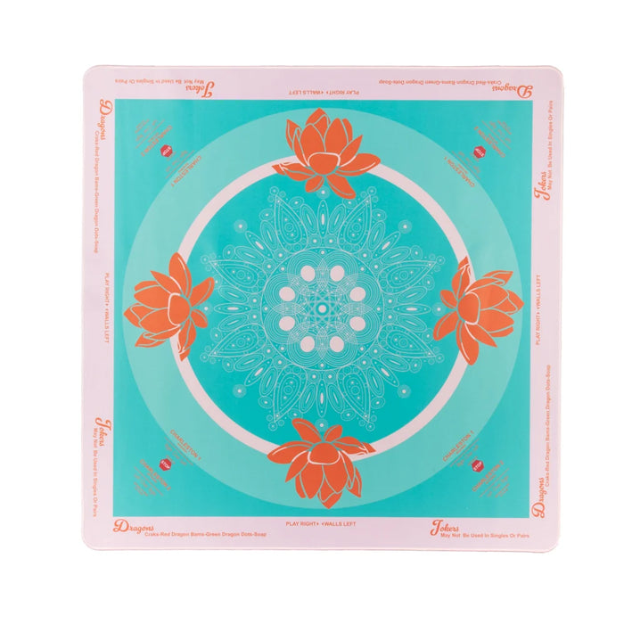 Teal game mat with orange lotus patterns on a white background