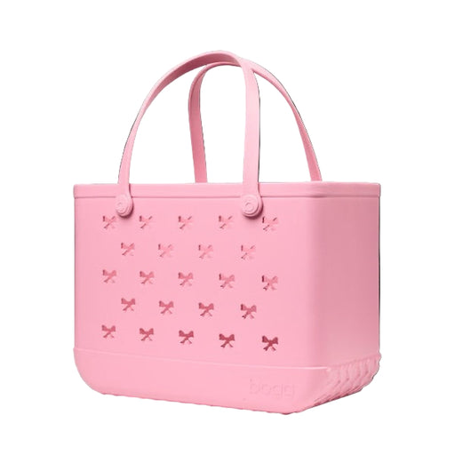 Pink tote bag with bow pattern on a black background