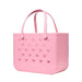 Pink tote bag with bow pattern on a black background