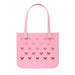 Pink tote bag with bow pattern on a white background