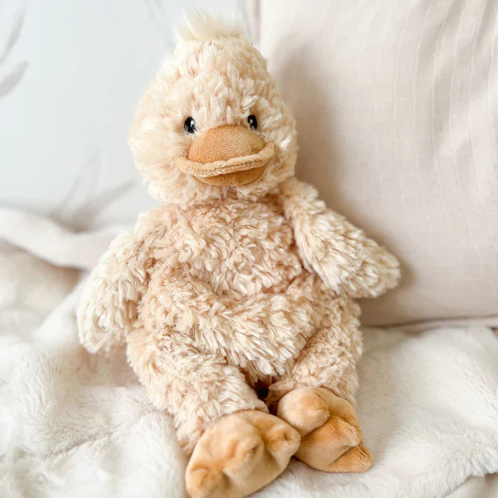 Plush duck toy on a soft white surface