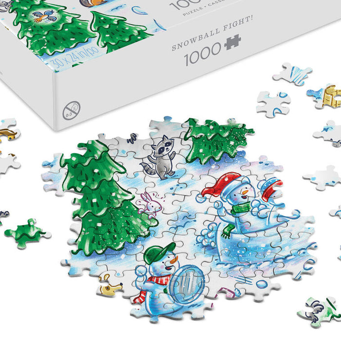 A 1000-piece jigsaw puzzle box labeled 'SNOWBALL FIGHT!' is shown partly opened, with several puzzle pieces scattered around it on a white background. The completed section depicts a winter scene with snowmen, evergreen trees, and a raccoon in a snowy setting.