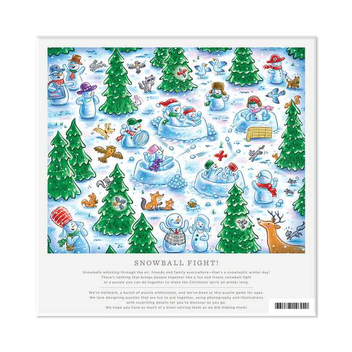 A square printed puzzle cover or game box front featuring a colorful cartoon winter scene with snowmen, trees, ice balls, and animals under the title 'SNOWBALL FIGHT!'. The design has a white border and a short block of text below the illustration.