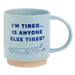 Light blue mug with text 'I'm Tired... Is Anyone Else Tired?' and a sleeping person illustration on a white background.