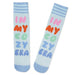 Light blue socks with colorful text 'IN MY COZY ERA' on a white background