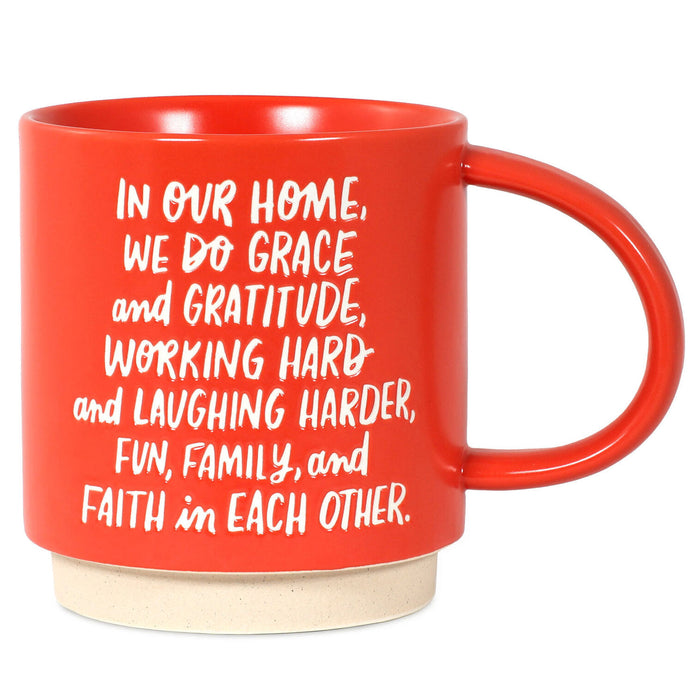 Red mug with white text on a white background