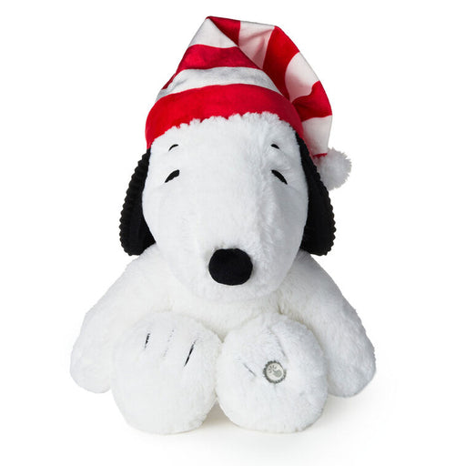 Plush toy resembling a dog with a red and white striped hat on a white background