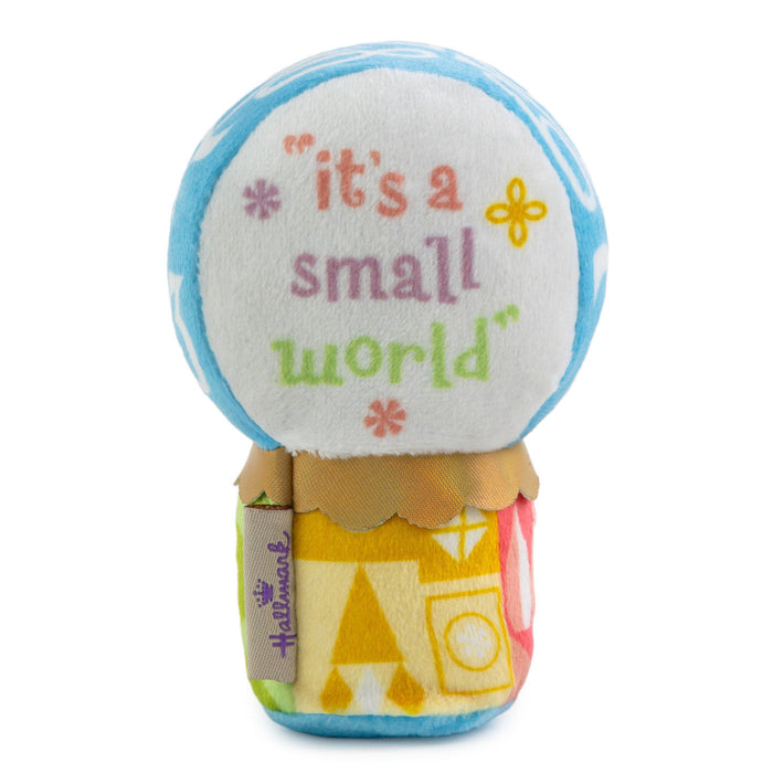 Toy snow globe with 'it's a small world' text on a white background