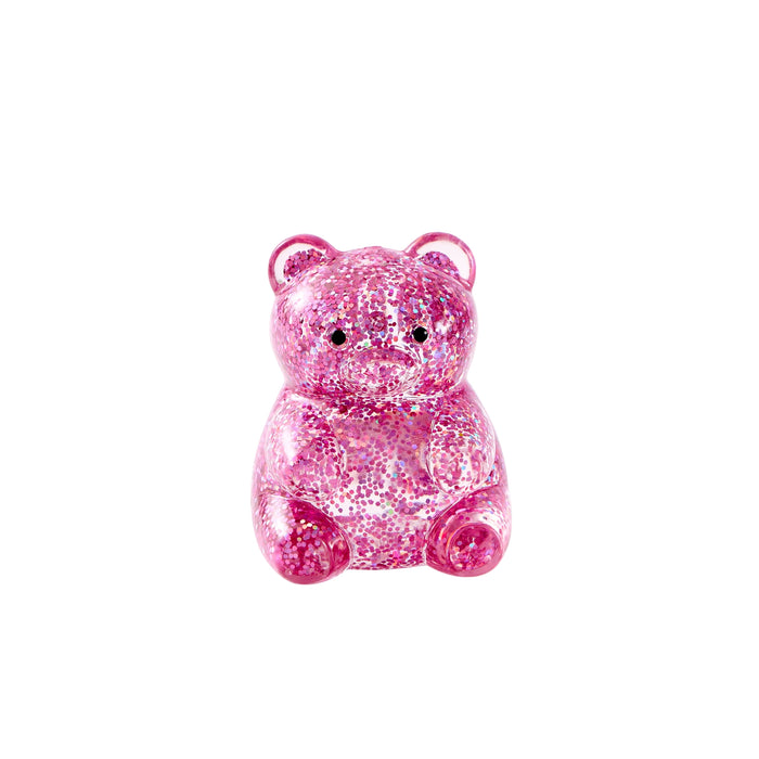 A small pink glitter teddy bear figurine with black eyes, centered on a plain white background.