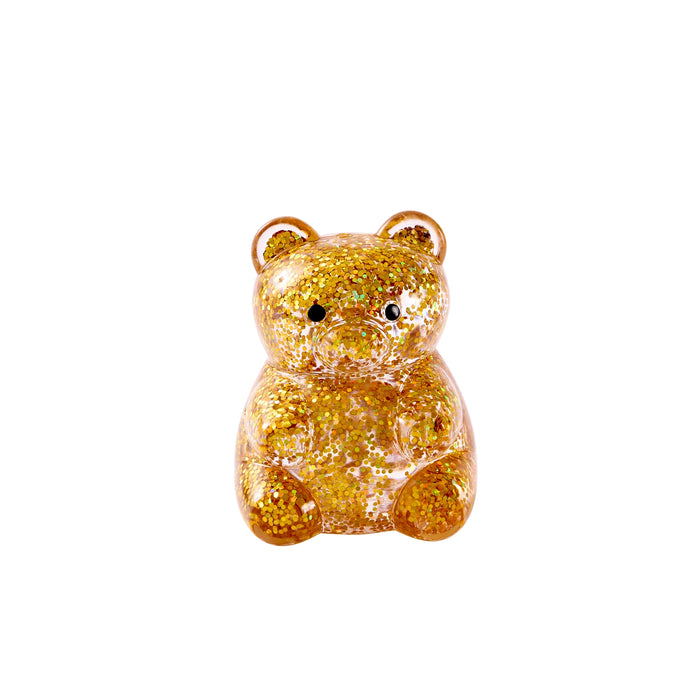 Gold glittery bear-shaped object on a white background