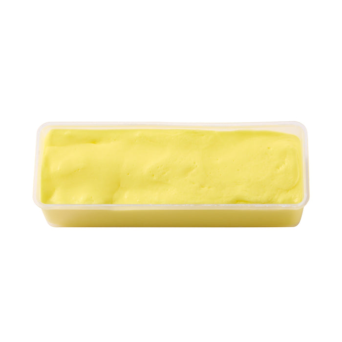 A rectangular plastic tub filled with bright yellow whipped cream or butter, photographed on a plain white background.