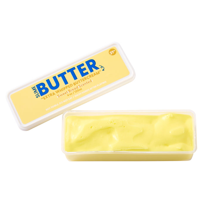 A tub of Swis. Butter Extra Whipped Butter Cream, showing the yellow cream inside a clear plastic container alongside its yellow and blue lid.