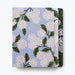 Floral notebook with white flowers and green leaves on a light blue background