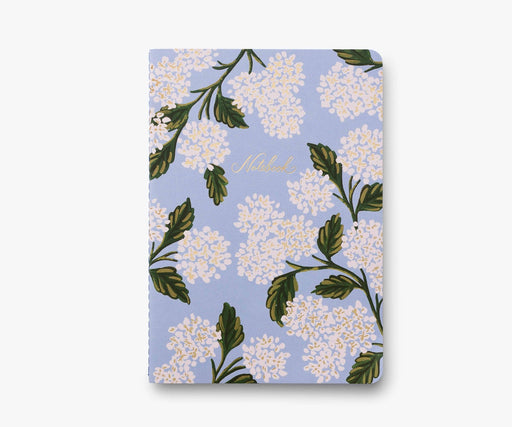 Notebook with floral design on a light blue background